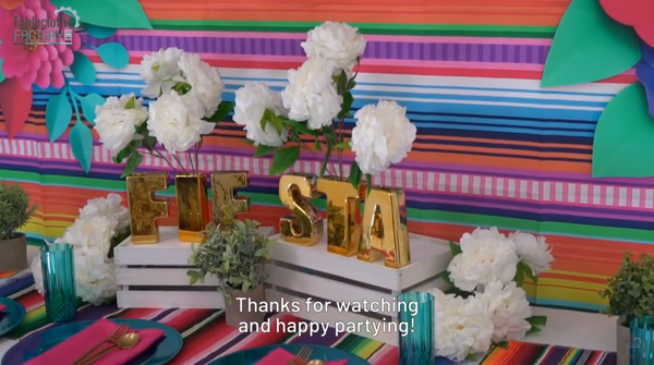 Gold letters, peonies, and colorful backdrop completing fiesta-themed party decorations.