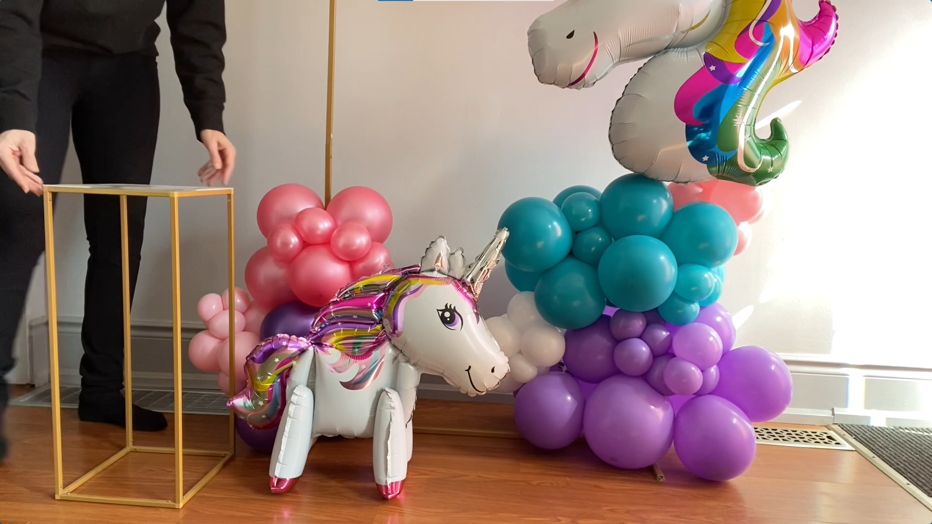 Standing unicorn balloon and column stand displayed to the side