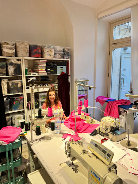 Workbench in Marta Scarampi's atelier, smiling Giulia in the background