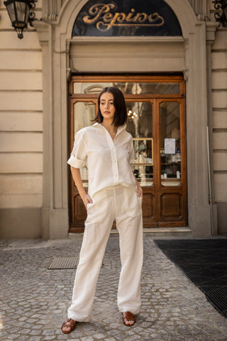Young woman dressed in linen in front of Turin ice cream shop Pepino