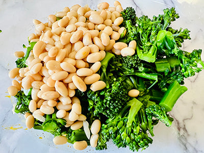 White beans and broccolini in a bowl