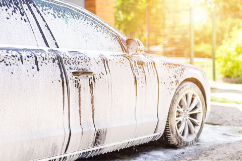 Outdoor car wash with active foam soap. commercial cleaning washing service  concept. Leave space to write messages. Stock Photo