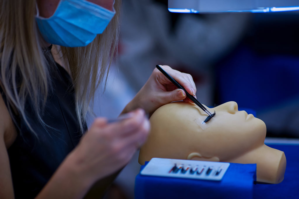 Lash tech course includes application of extensions on a mannequin. Cartel Lash