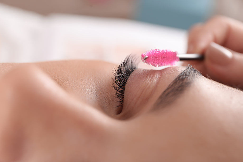 Woman taking care of eyelash extensions for retention. Cartel Lash