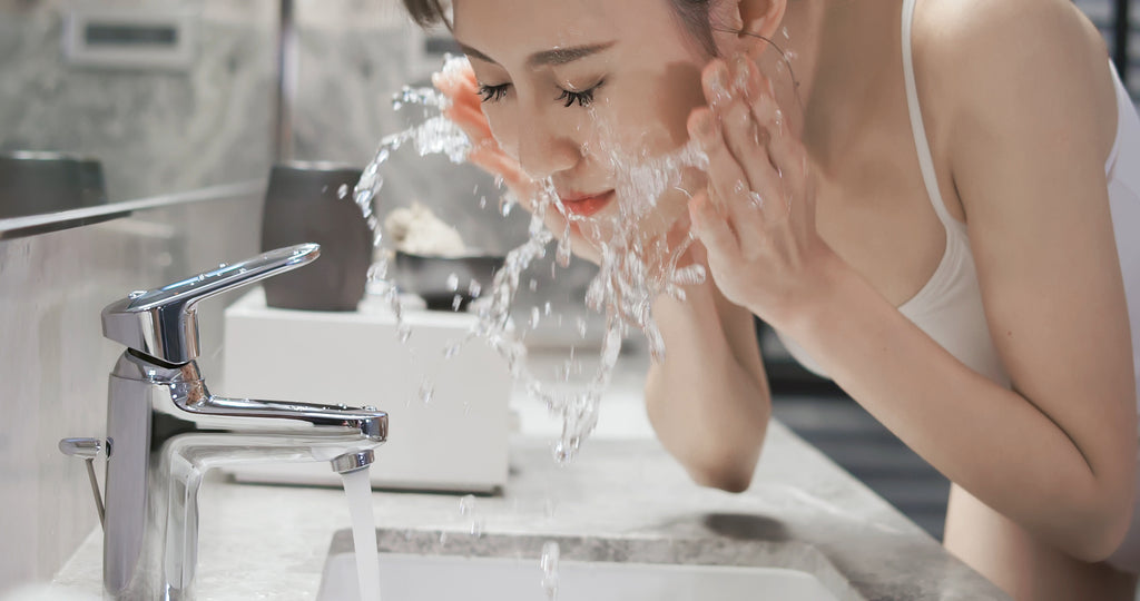 Woman washing her face and lashes for retention. Cartel Lash