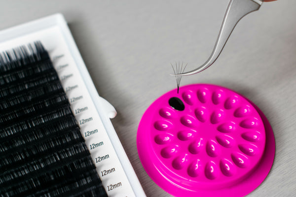 Volume fan made from eyelash extension kit being dipped into lash glue. Cartel Lash 