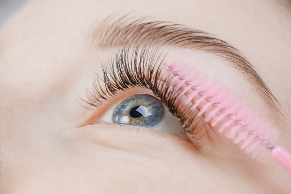 Eyelash extension procedure. Beautiful female eyes with long lashes. Cartel Lash