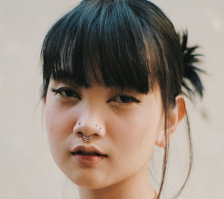 Young woman wears facial body jewelry and body piercing jewelry from bm25.com