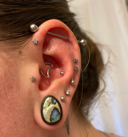 Ear curation piercing inspiration from a BM25 customer featuring abalone teardrop plugs and basic barbells