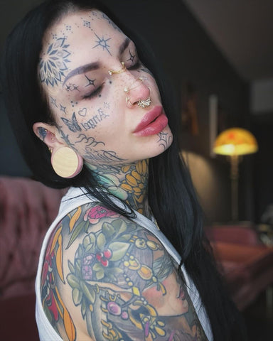Piercing inspiration for ears and septum stack featuring BM25 customer wearing large crocodile wood gauges with a 14k gold septum piercing ring stack.
