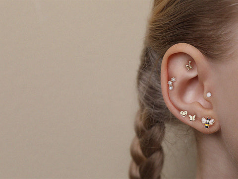 Young woman wears la golden Earscape Ear Curation from BM25.com body jewelry