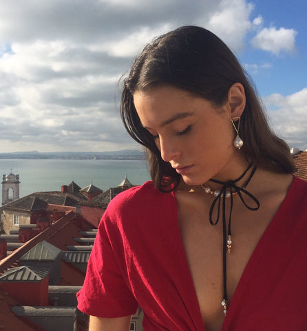 Model wearing sterling silver triangle and baroque pearl earrings