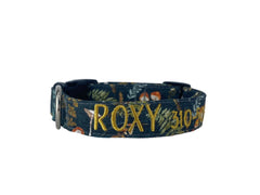 A navy blue dog collar with toadstool illustrations.