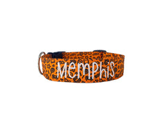 An orange dog collar with halloween doodles on it.