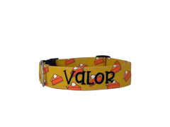 A mustard colored dog collar with pumpkin pie illustrations.