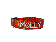 An orange dog collar with vintage halloween motifs.