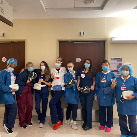 Healthcare workers wearing their donated Go Dash Dot bags