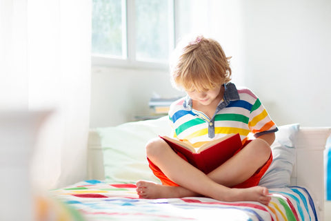 Junior infant with a gaeilge activity book