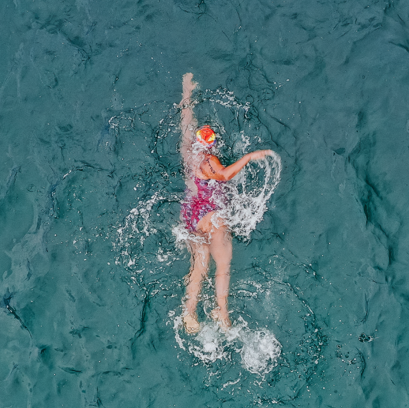 woman wearing a swimsuit swimming in ocean