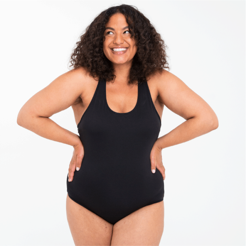 woman wearing black swimsuit and smiling