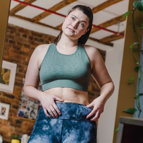 woman wearing gym clothes holding waist