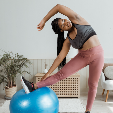 woman stretching on bouncy ball