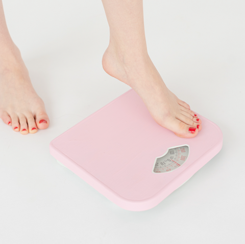 woman's feet on weighing scales