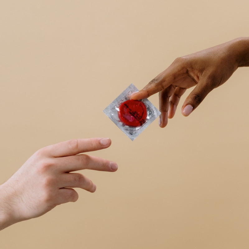 condom being passed from hand to hand