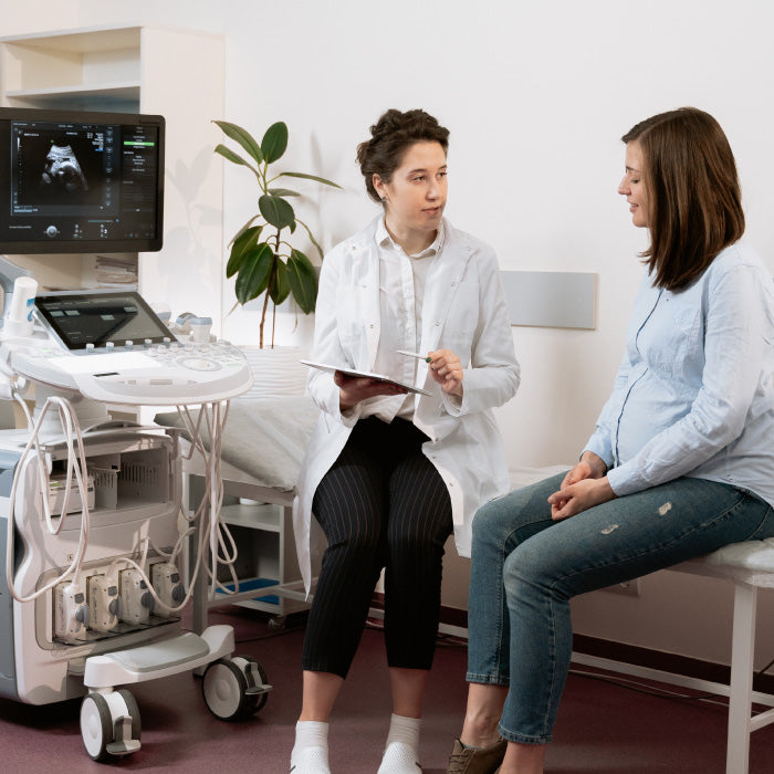 woman sitting in front of ultrasound machine