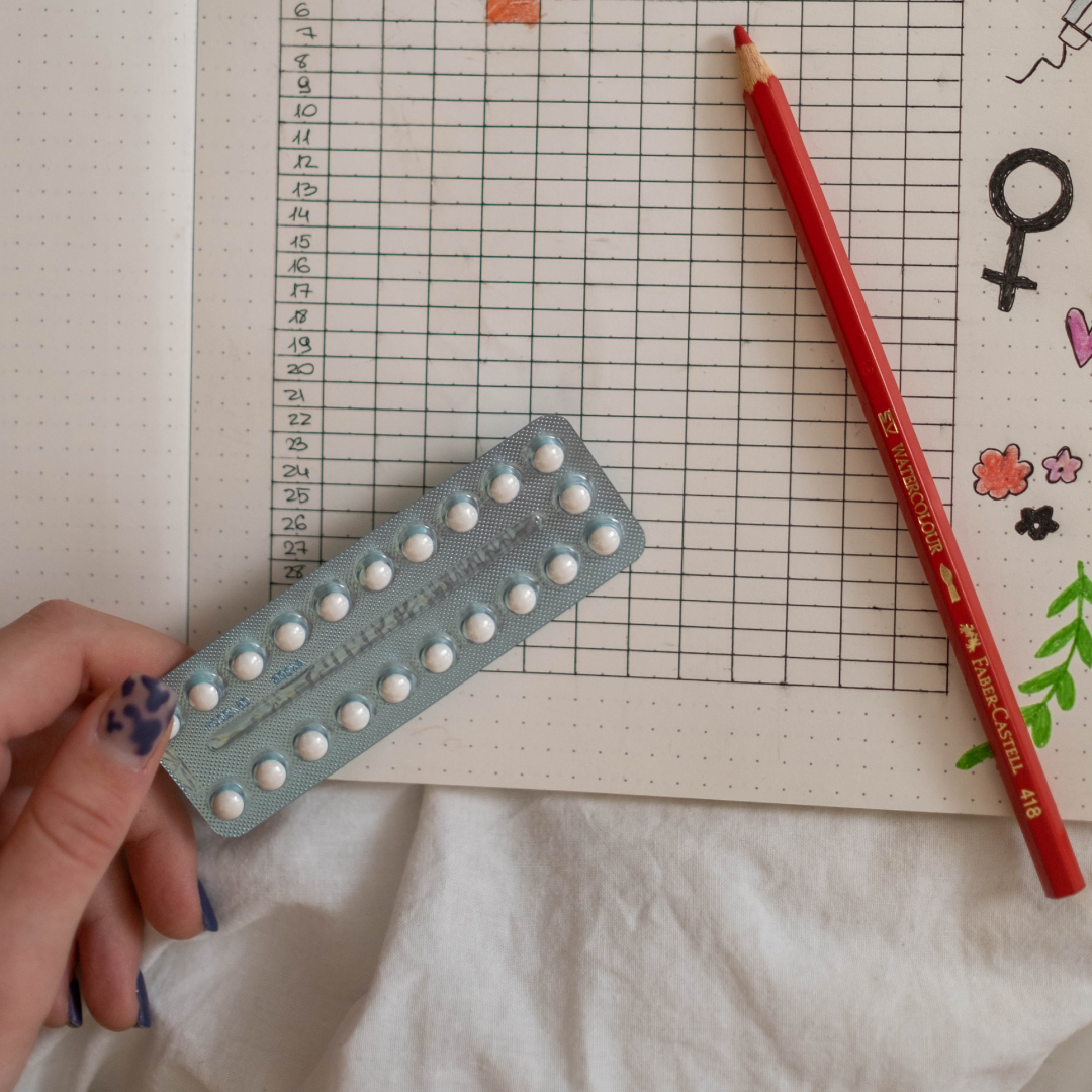 birth control pill packet with calendar and red pencil