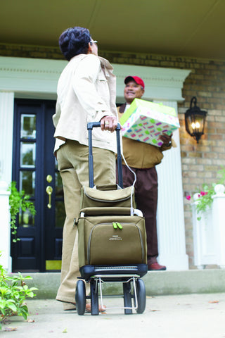 Woman using a travel cart to transport the SimplyGo Portable Oxygen Concentrator.