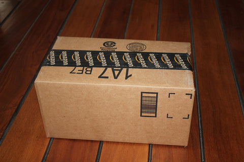 Box on hardwood floor with Amazon label