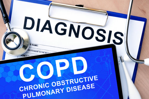 Clipboard with the word "diagnosis" written on it and tablet with "COPD" on the screen.