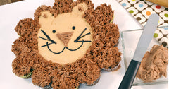 A RADA Super Spreader next to our Lion Cupcake Cake with a dollop of frosting next to the spreader