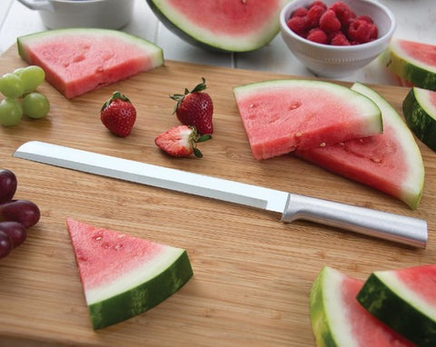 RADA Cutlery Ham Slicer with triangular slices of watermelon, halved strawberries and a string of grapes around it