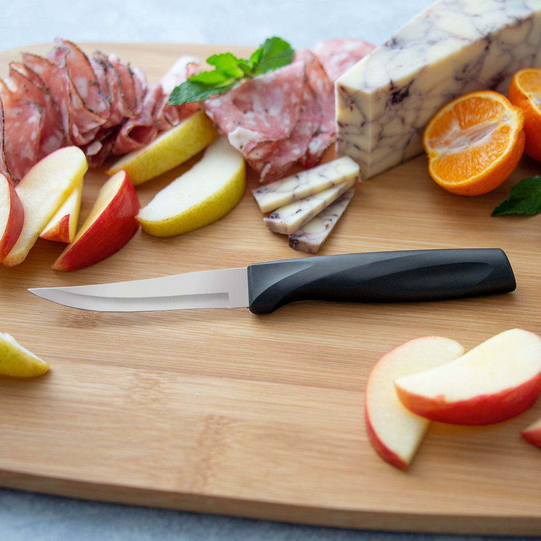 Anthem Heavy Duty Paring Knife surrounded by meats and cheeses on a cutting board.