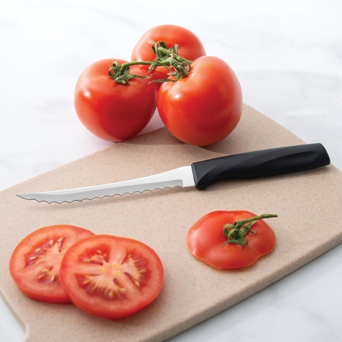 Rada Cutlery Anthem Wave Tomato Slicer with sliced tomatoes. 