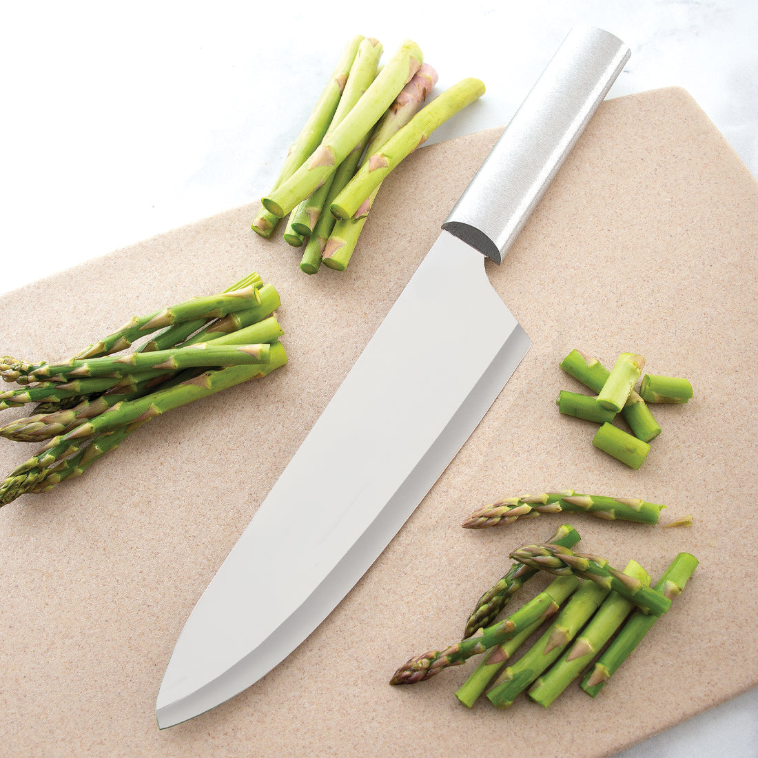 French Chef Knife with silver handle on cutting board with asparagus