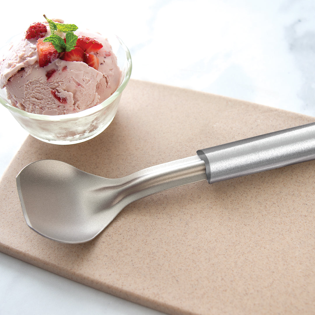 Silver handle Ice Cream Scoop with a bowl of strawberry ice cream.