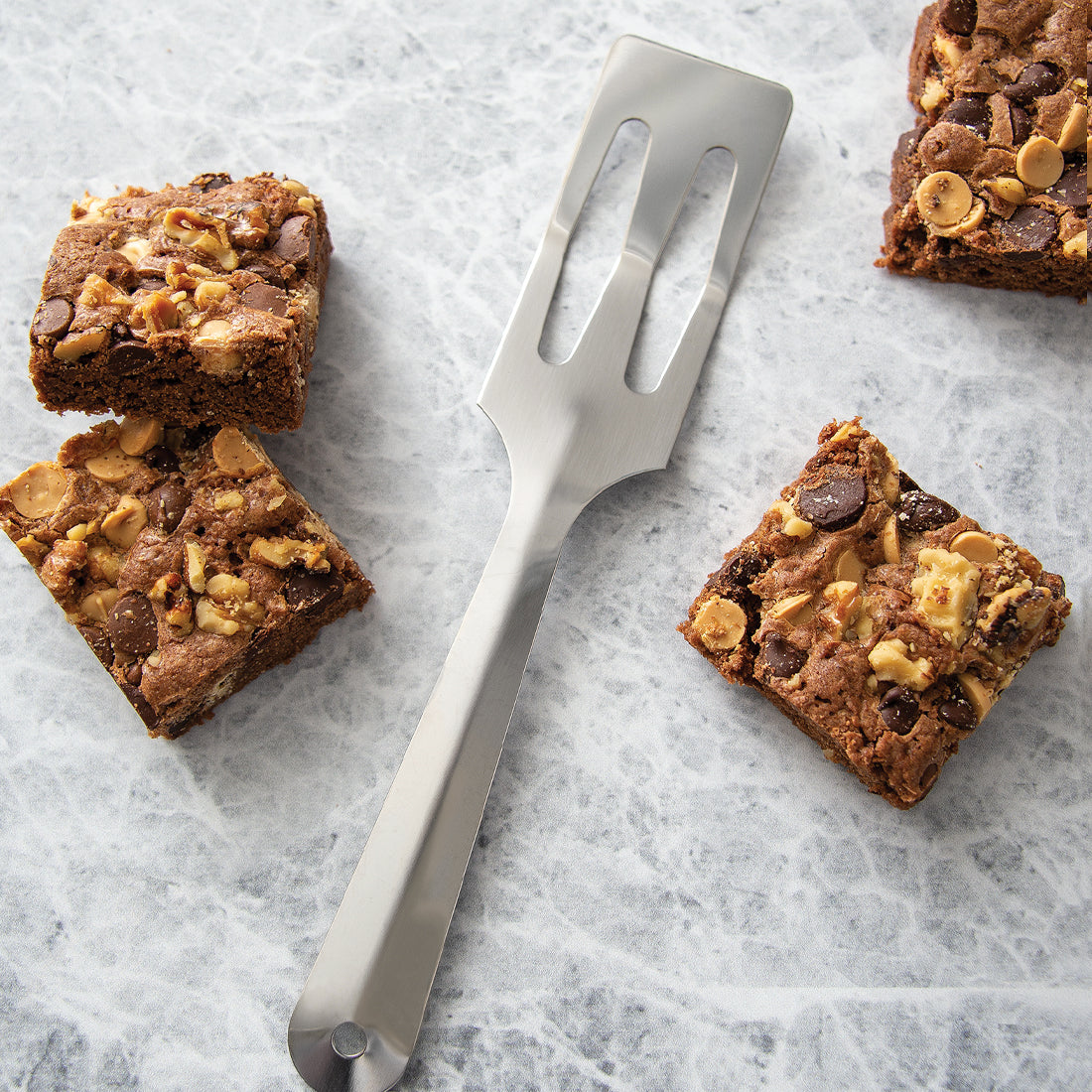 Serverspoon spatula shown on cutting board with brownies.