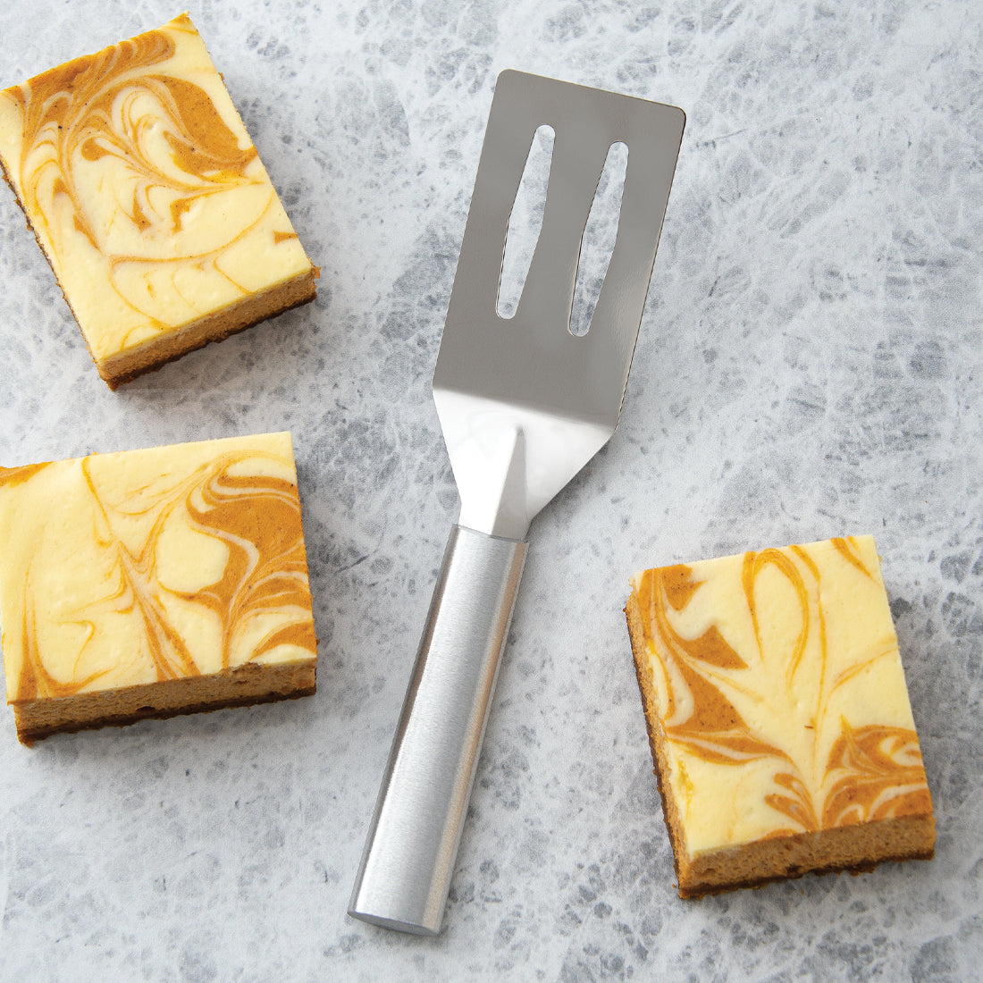 Rada Cutlery Spatula with silver handle and pumpkin cheesecake squares.