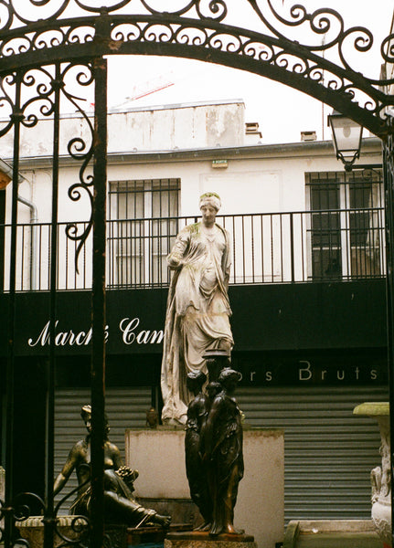 A statue in an alleyway of Paris.