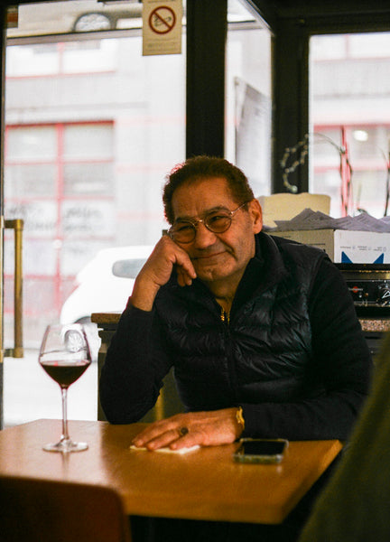 A man sat with a wine glass.