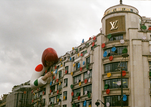 Yayoi Kusama painting over the Louis Vuitton building in Paris.