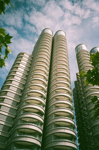 A tall building with many storeys and the sky in the background.