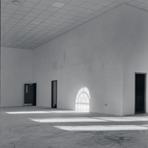 Black and white ray of light in an large empty room.