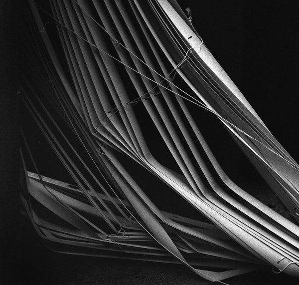 A collection of broken blinds, in black and white.