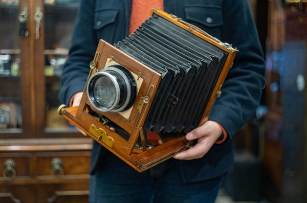 A large wooden camera being held.