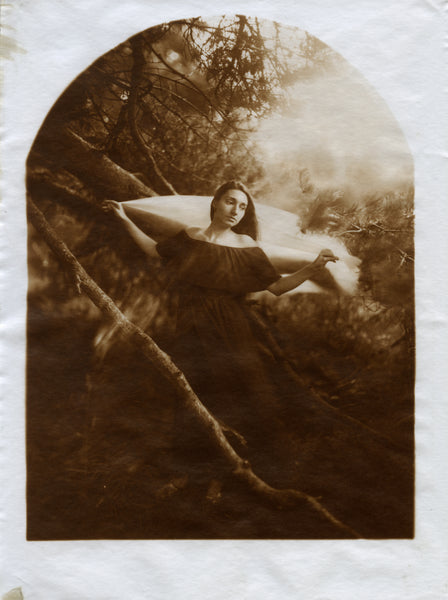 A print of a woman holding a veil in the forest in sepia tones.