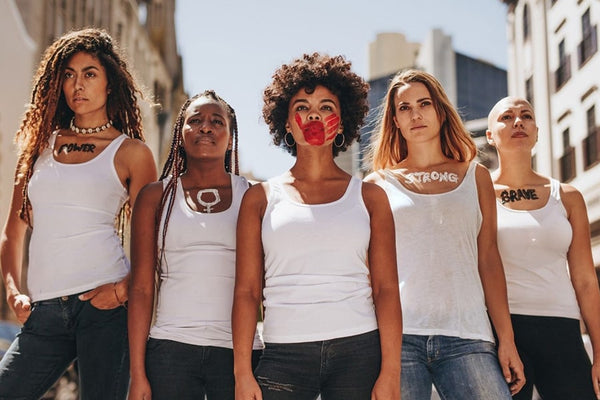 A group of women participating in a feminist protest, united for gender equality and advocating for education on women's rights.